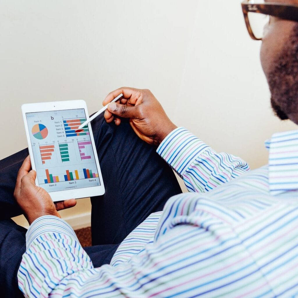 person sitting on chair holding iPad